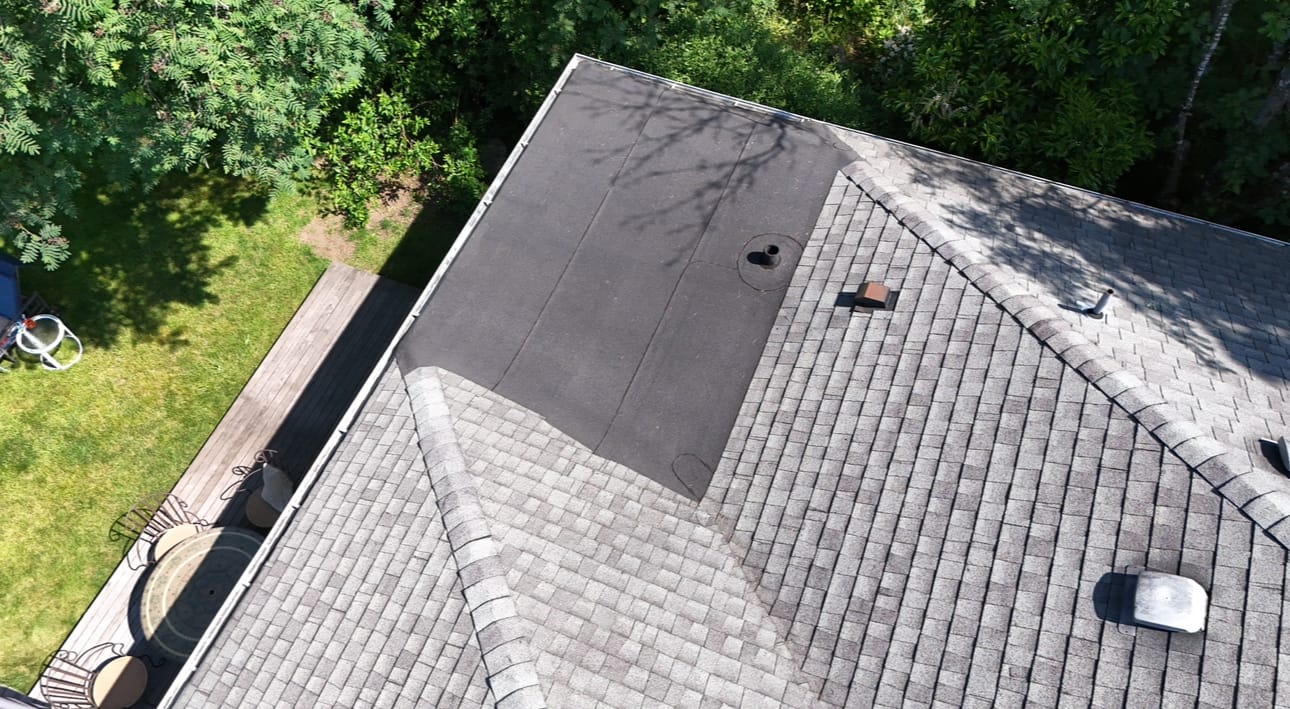 Mixed roof showing flat and shingle sections